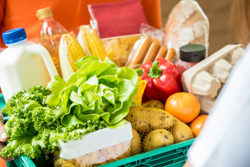 Delivery man delivering food to customer at home - online grocery shopping service concept