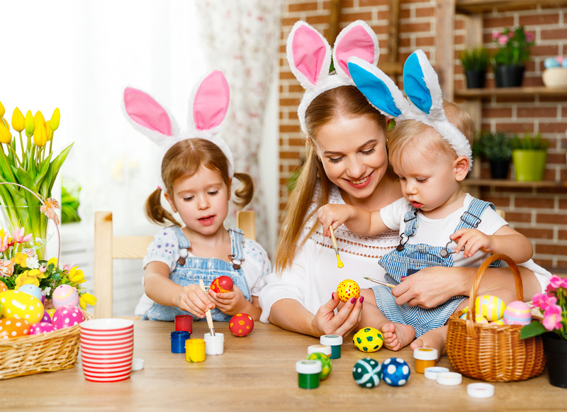 Happy easter! family mother and children paint eggs for holiday Easter at home