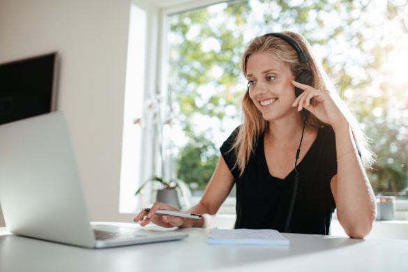 woman listening to headphones at computer
