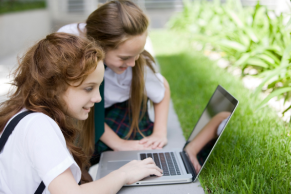 School girls using laptop